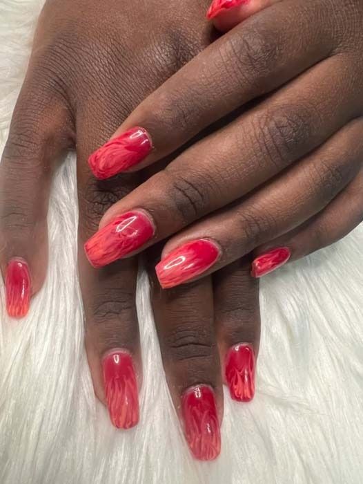 Red and coral marbled swirl nail art manicure