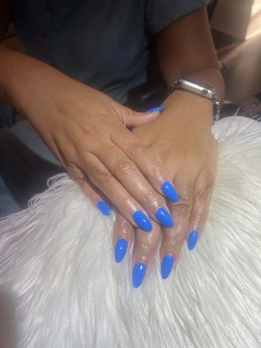 Blue stiletto nail manicure